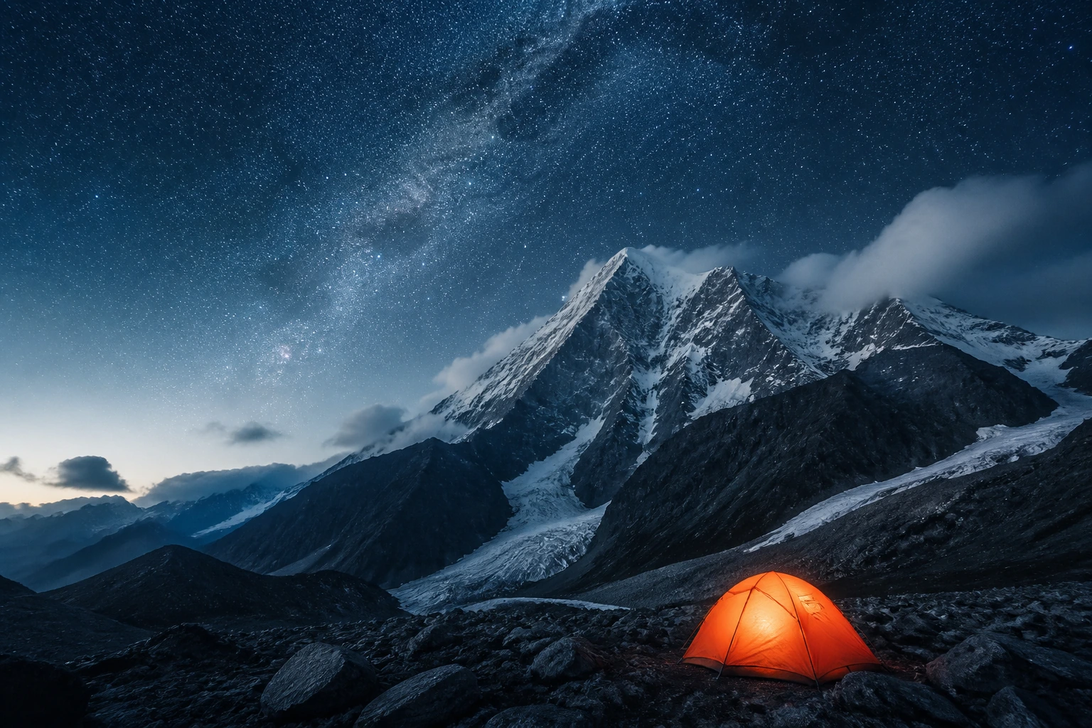 A glowing tent under a sky full of stars in a snowy mountain valley
