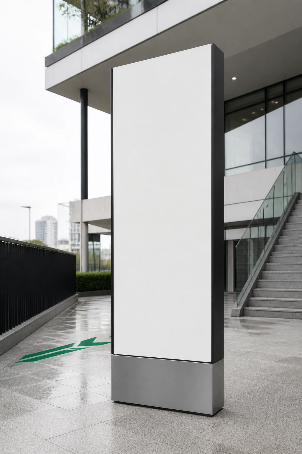 A tall freestanding sign totem outdoors on a paved plaza under overcast light