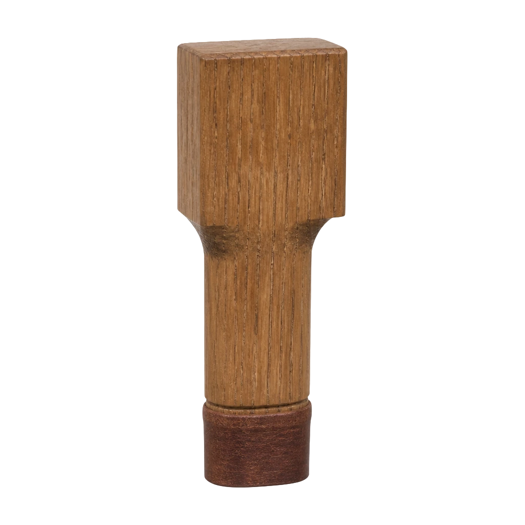 A wooden organ pipe stopper block with a leather-faced plug